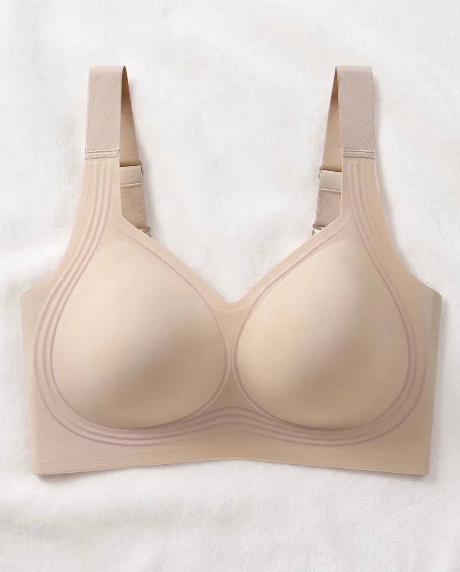 Nuvia beige tono piel de frente: estructura flexible, tirantes anchos y laterales altos, sin varilla